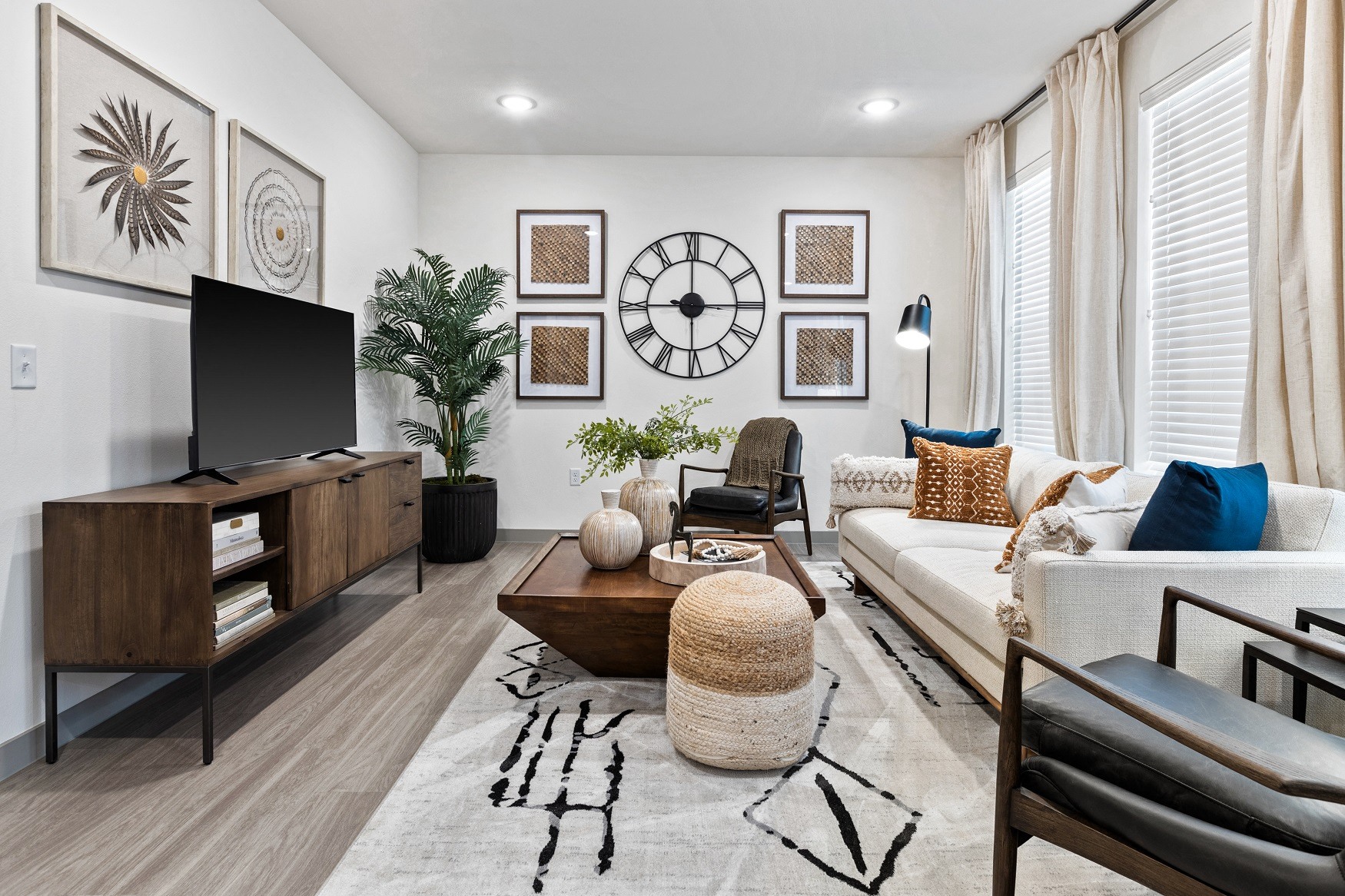 a living room with a large clock on the wall and a couch